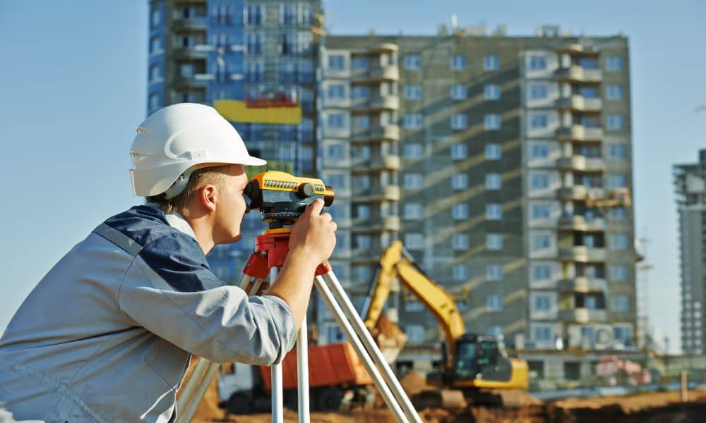 Professional Land Surveyor Preparing Site for Zoning Review - ALTA SURVEY Tennessee Land Surveyor with leveling instrument on a commercial property to assist with zoning and access compliance