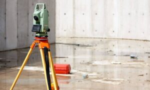 Surveying equipment used to measure property height for an elevation certificate after rainfall