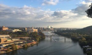 Aerial view of riverfront showing slopes and water levels that highlight why homeowners often need an elevation survey before building