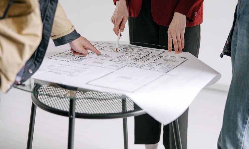Buyers reviewing an ALTA land survey document during a commercial property closing