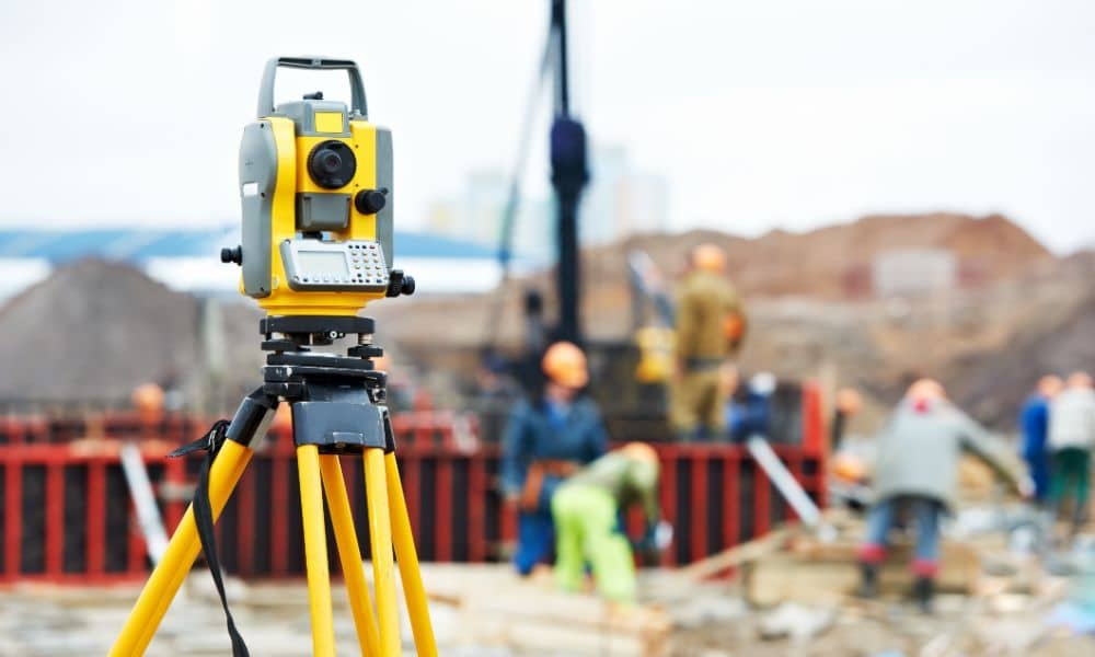 Surveying equipment on a construction site used for measuring elevation and preparing Flood Elevation Certificates.