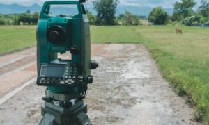 land survey - Digital surveying tool set up in a rural field to measure property boundaries before land purchase
