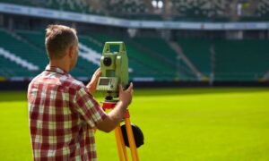 Alta land title survey mega stadium - ALTA SURVEY Tennessee Land surveyor using a total station to measure a stadium field during an ALTA Land Title Survey for a major construction project