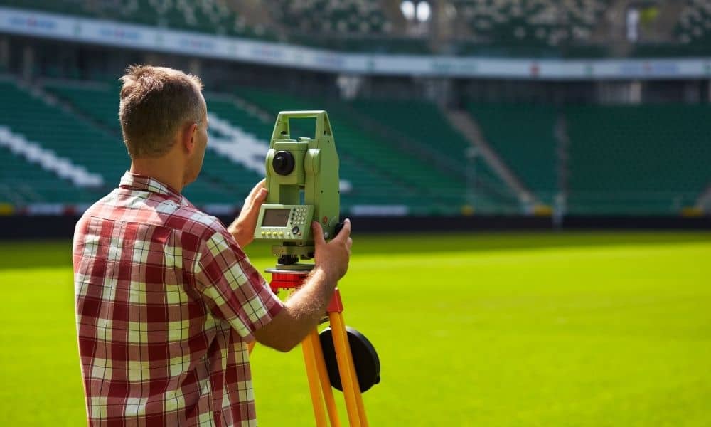 Alta land title survey mega stadium - ALTA SURVEY Tennessee Land surveyor using a total station to measure a stadium field during an ALTA Land Title Survey for a major construction project