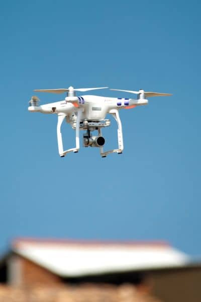 Residential roof drone inspection - ALTA SURVEY Tennessee Drone survey equipment inspecting a residential roof from the air