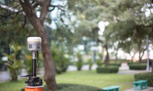 Land surveying equipment set up in the field to verify mapping data accuracy