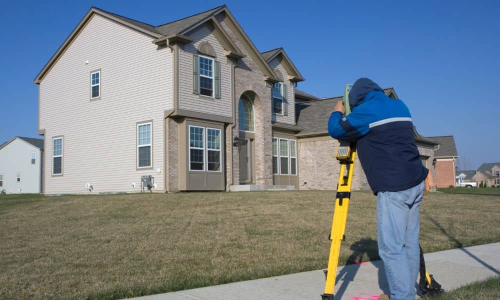 Land surveyor completing a property survey for a residential permit review