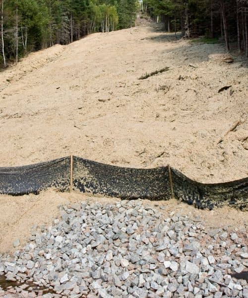 Silt fence failed erosion sediment runoff - ALTA SURVEY Tennessee A silt fence overwhelmed by sediment, showing why a stronger erosion control plan is needed during heavy storms