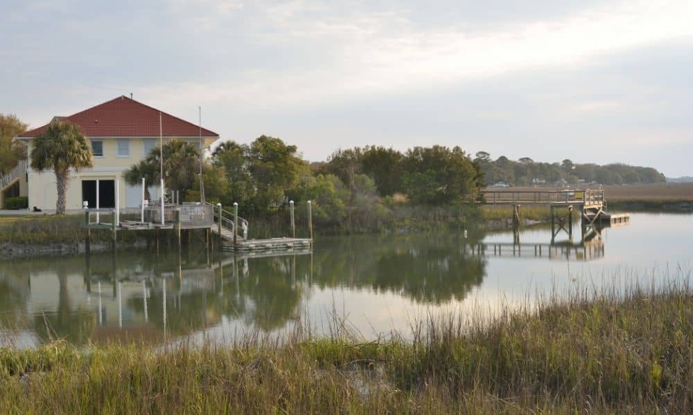 Creekside residential home on low-lying land where a flood elevation certificate helps clarify how the structure sits relative to surrounding ground