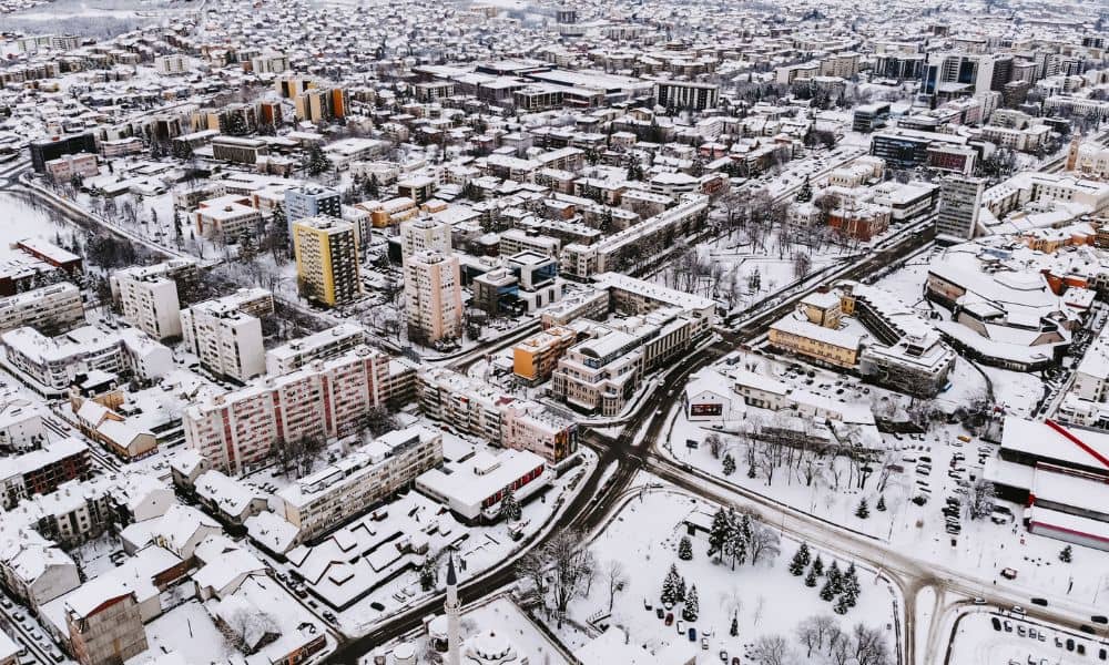 Aerial view of a city during a winter storm showing how survey mapping supports emergency response