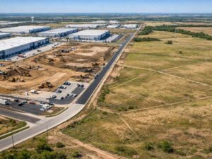 Aerial view of industrial park development beside undeveloped land showing land changes and risks before purchasing property