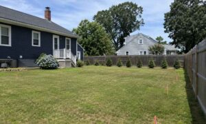 Backyard survey stakes for a detached garage project, showing what can affect the average cost for a land survey